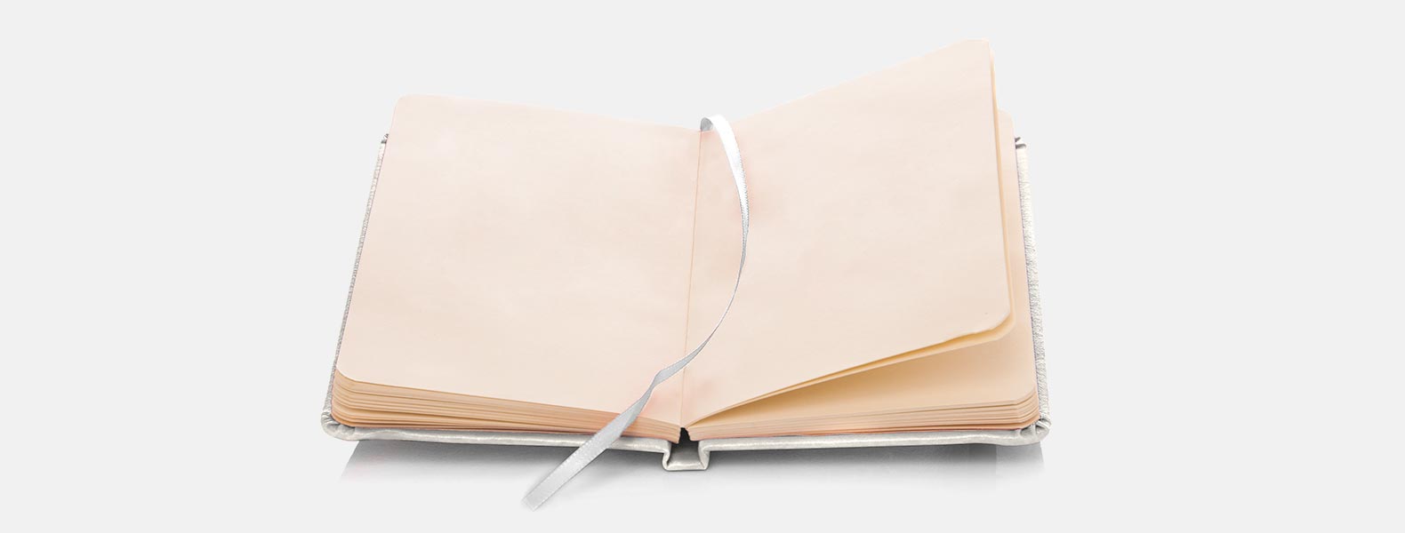 Caderno para anotações branco com capa dura em Courino. Conta com 80 folhas não pautadas e elástico para fechamento. Gramatura da folha de 70 g/m2.